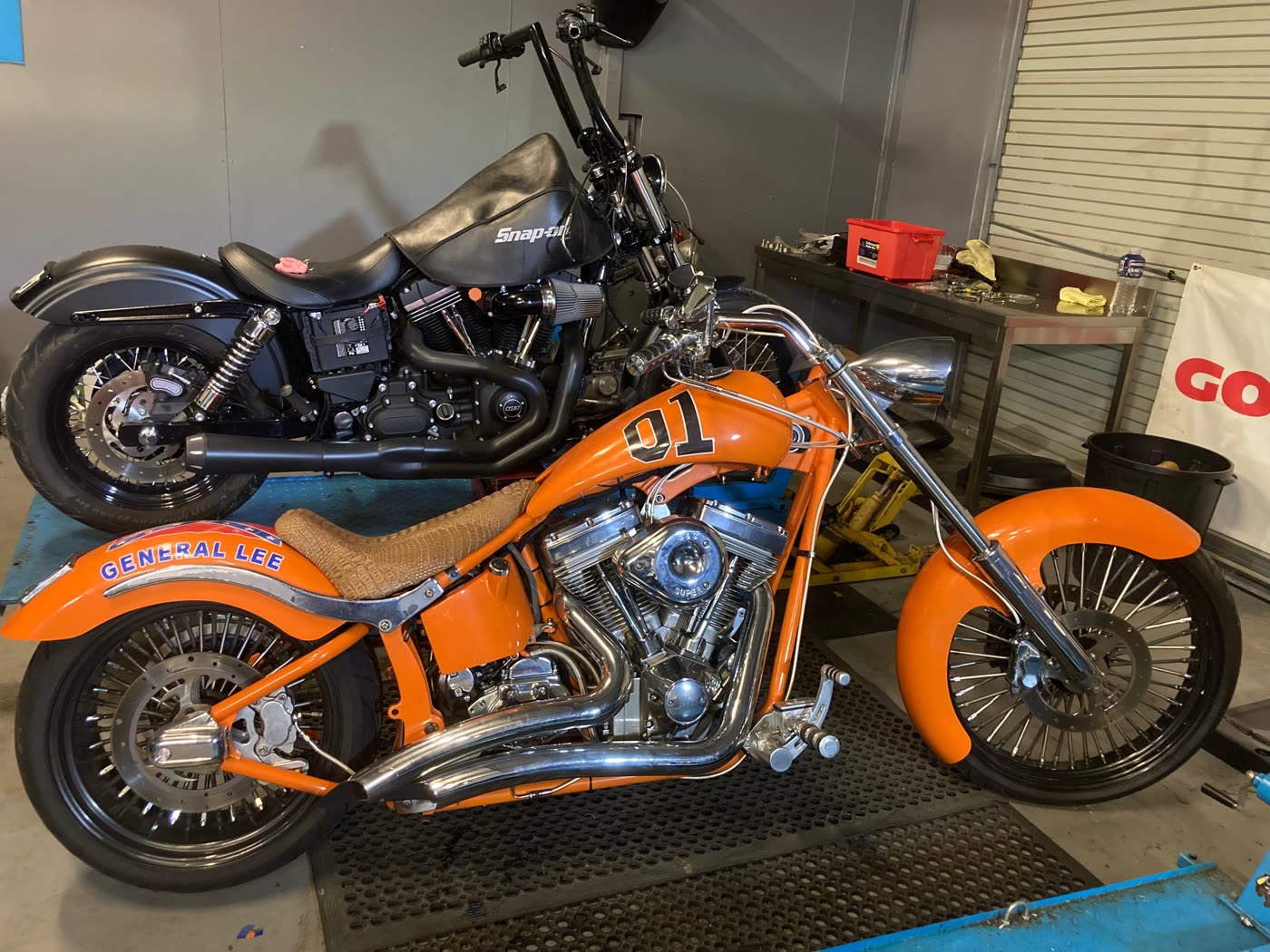 Orange custom chopper in the Kidd Motorcycles workshop